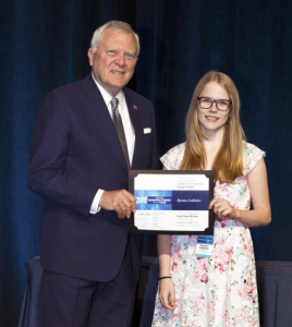 Kyrsten Ledbetter of RockDale County middle school receives 1st place certificate from Governor Nathan Deal for her artwork reflecting the importance of manufacturing in Georgia.