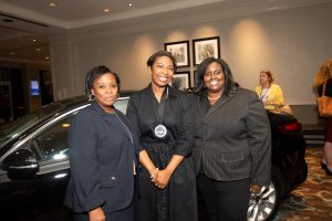 Crystal Wright in front of car with Dr. Debra Gordon and Dr. Tessie Bradford.