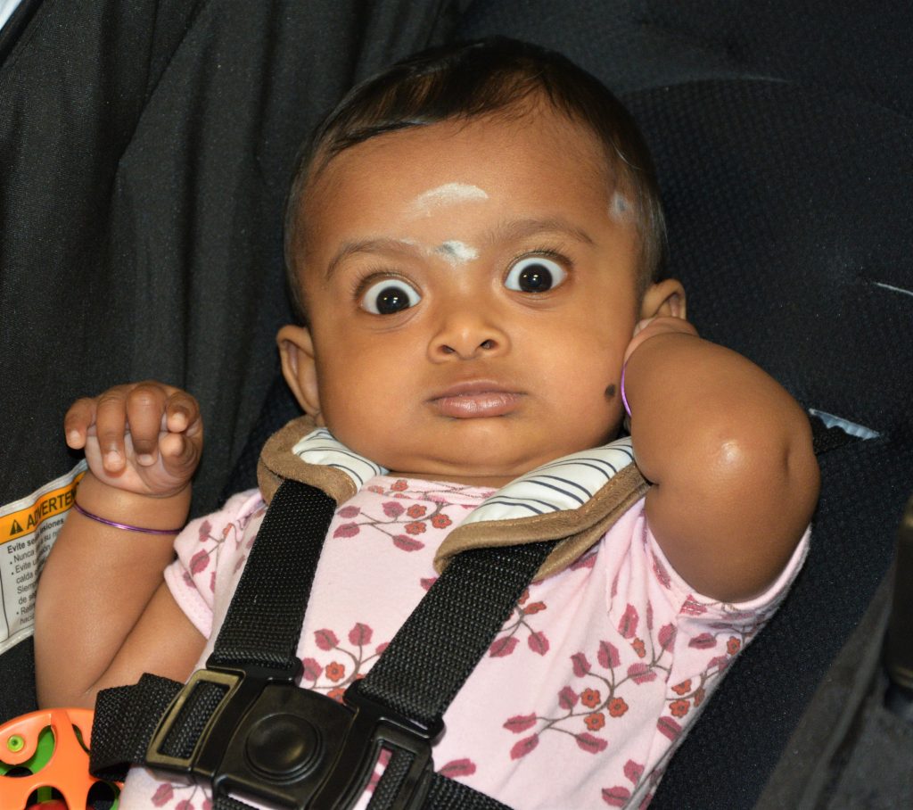Wide-eyed baby in stroller