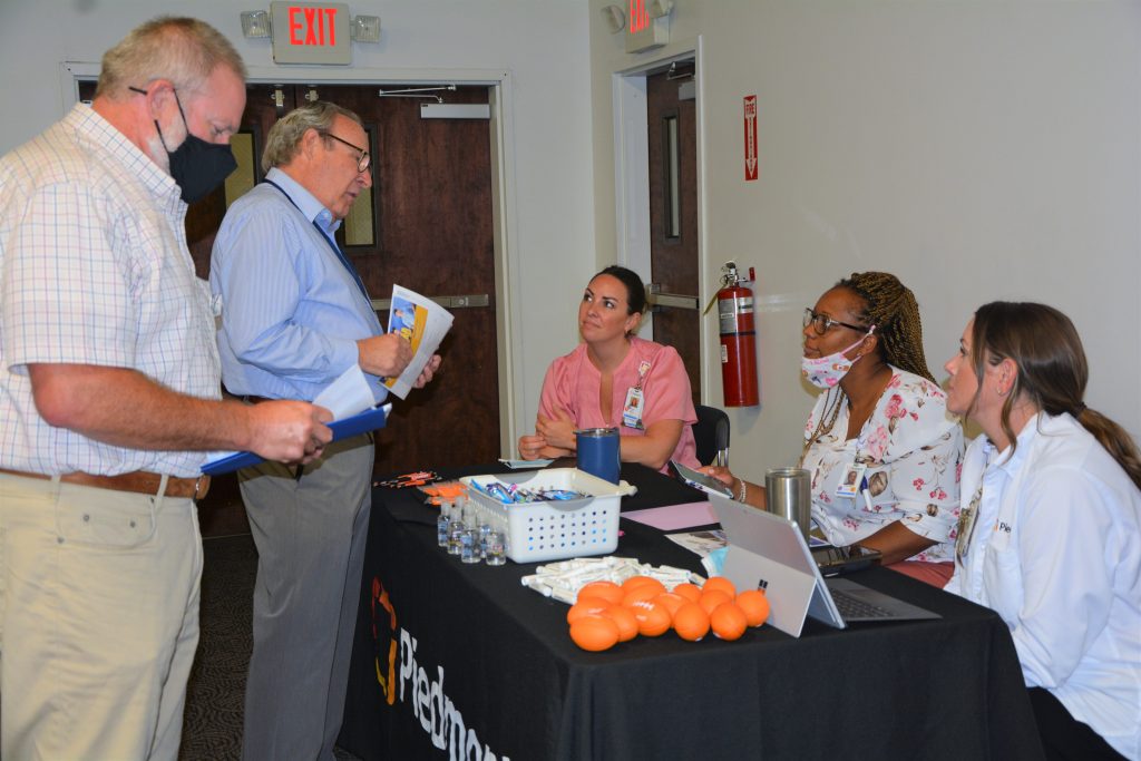 Piedmont health care booth with attendees