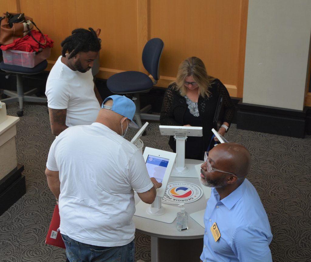 Attendees registering for the job fair at the check-in kiosk