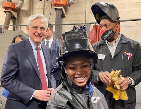 AG Merrick Garland smiling with welding student