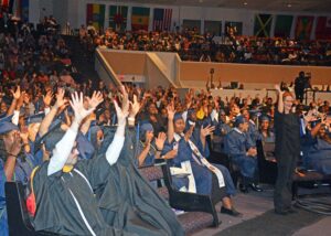 Crowd waving hands to show applause for deaf students