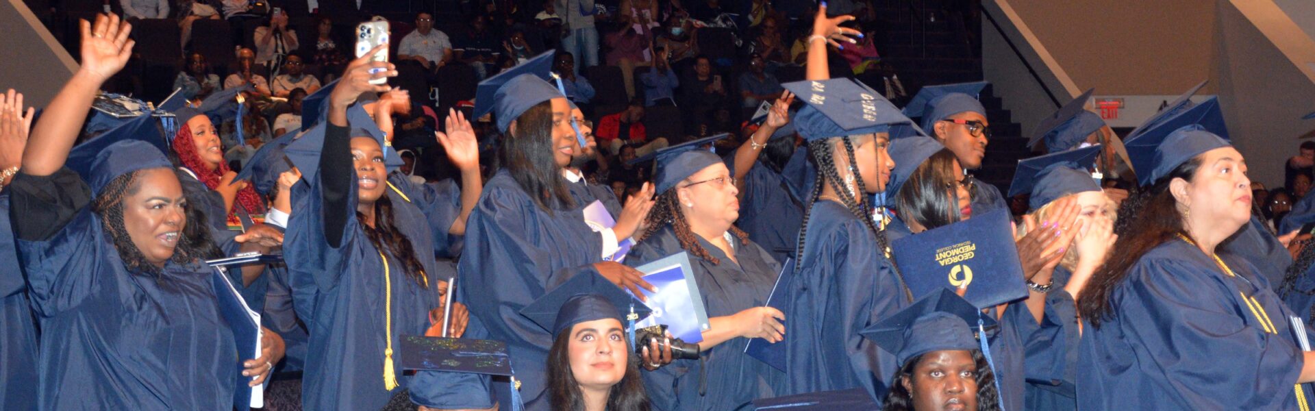 Graduates smiling and cheering