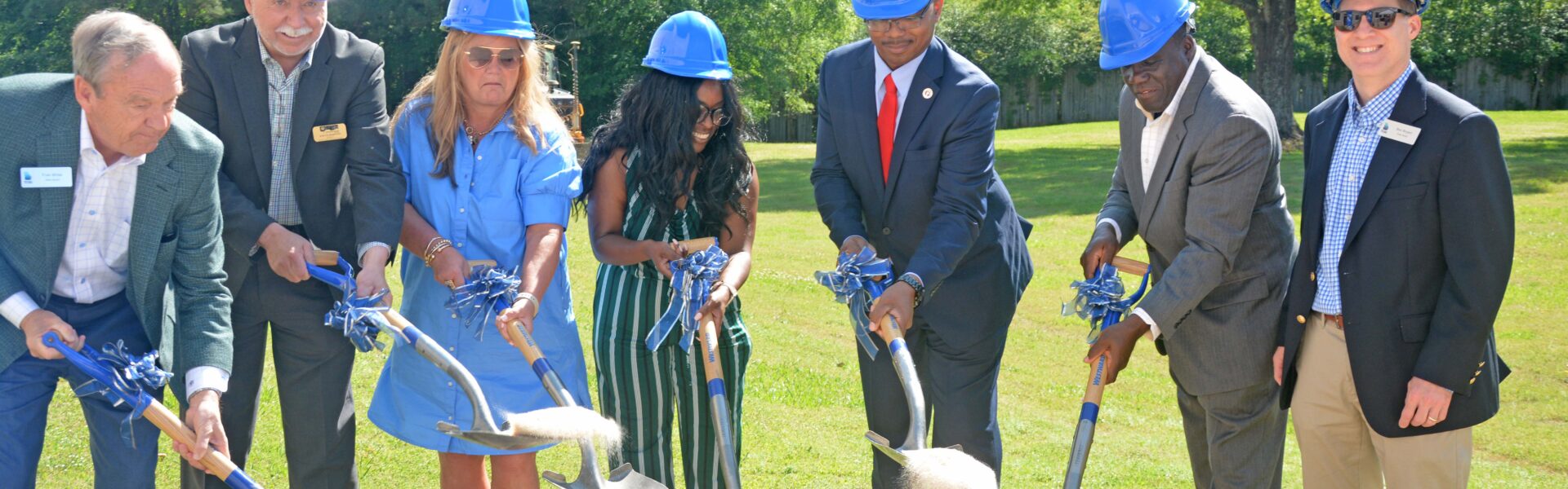 Dignitaries shovel dirt to officially break ground on the project.