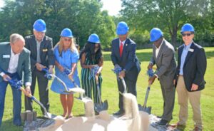 Dignitaries shovel dirt to officially break ground on the project.