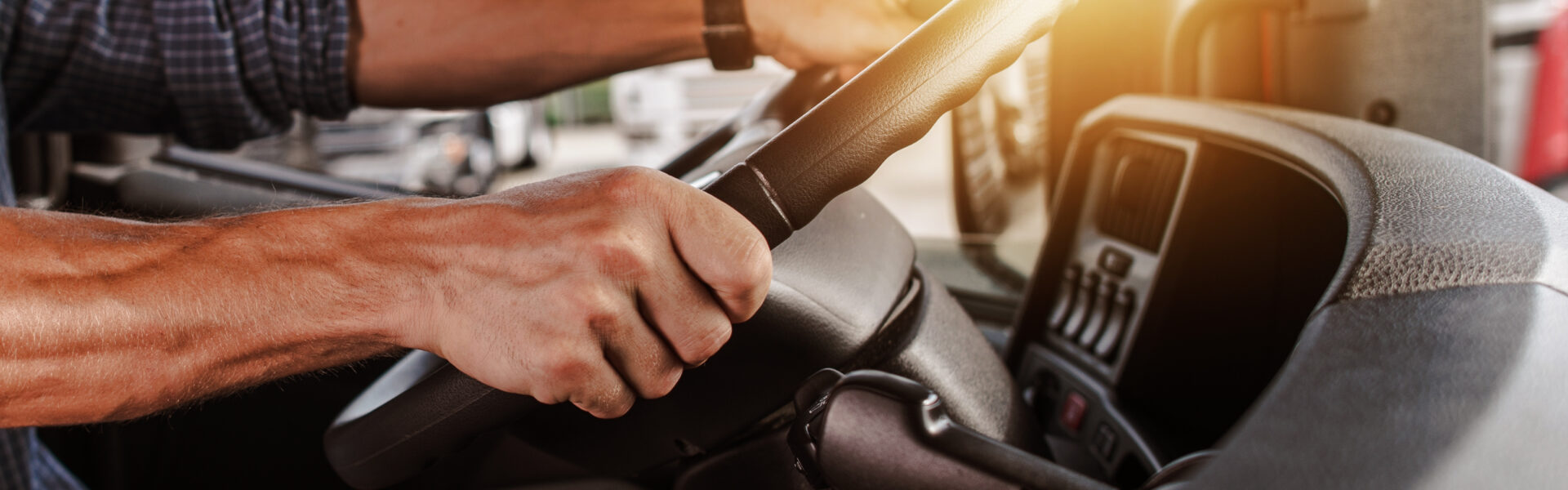 Hands on wheel of big rig truck